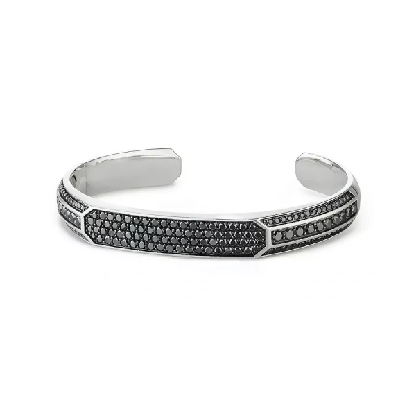 A silver bracelet with black stones on it