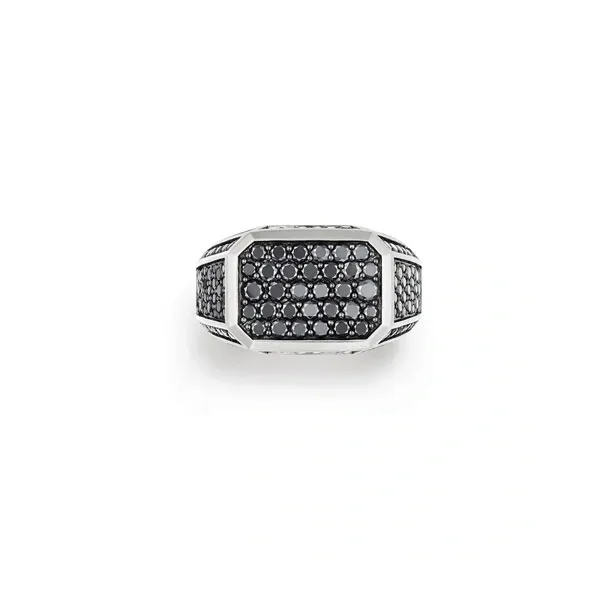 A silver ring with black and white diamonds.