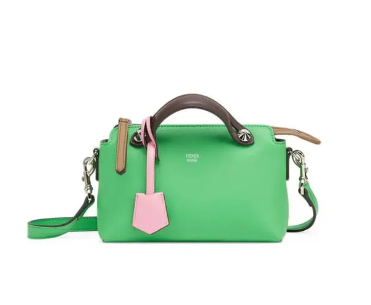 A green bag with pink and brown handles.
