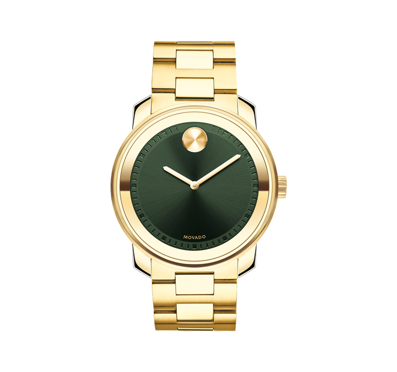 A gold watch with green face and yellow hands.