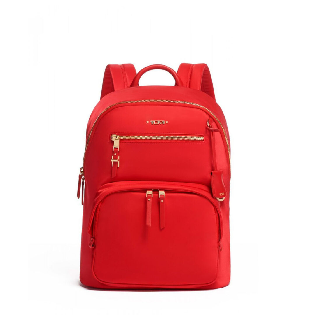 A red backpack with gold hardware and zippers.