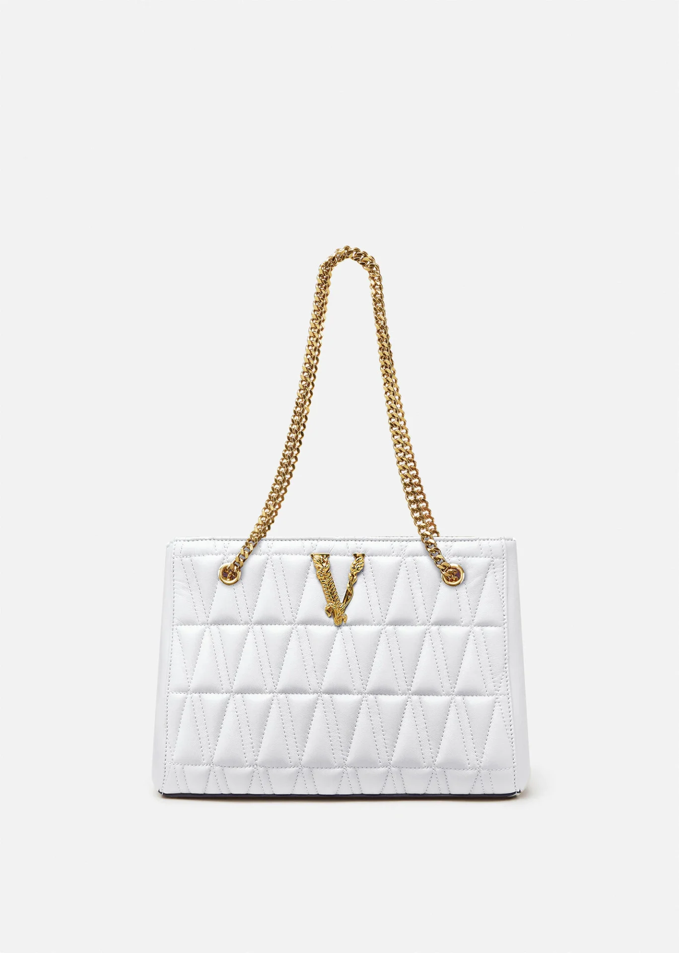 A white purse with gold chain handles and a v on the front.