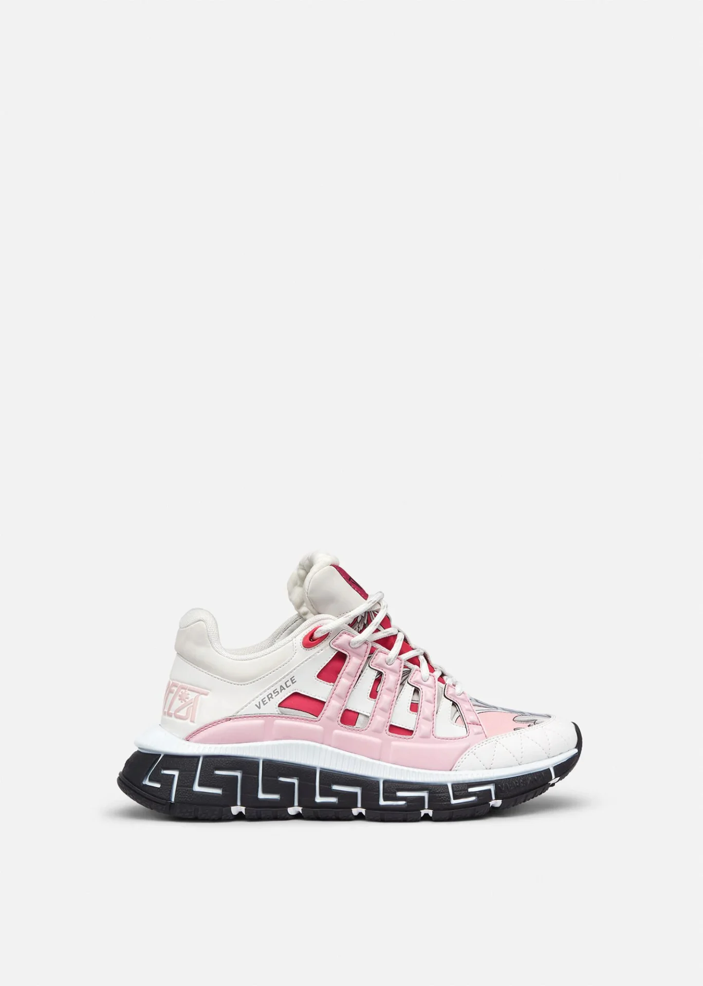 A pair of pink and white sneakers with black laces.