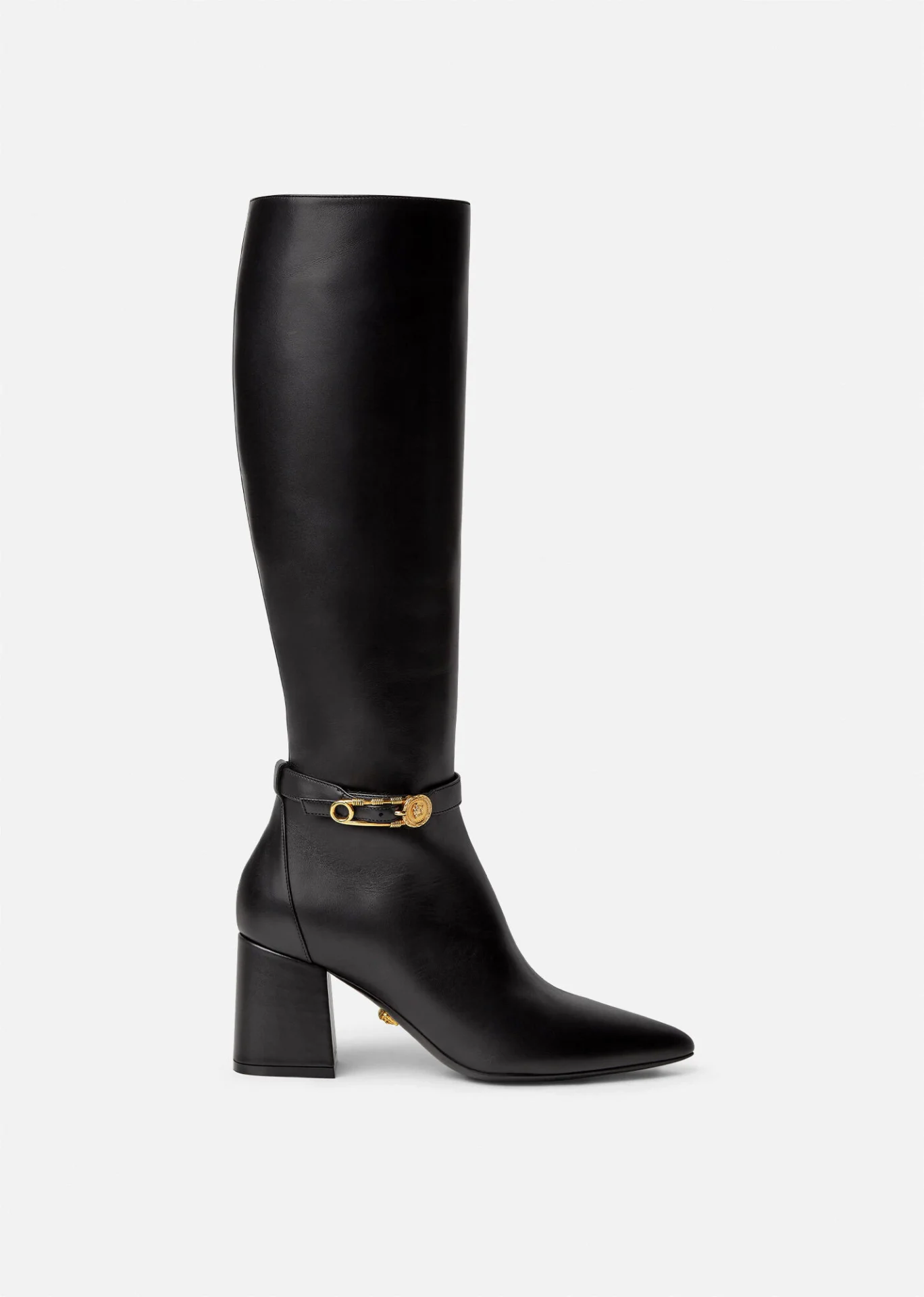 A black leather boot with gold hardware.