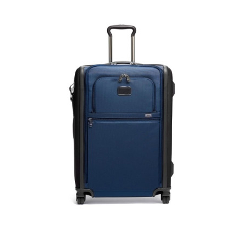 A blue suitcase is sitting on the ground.