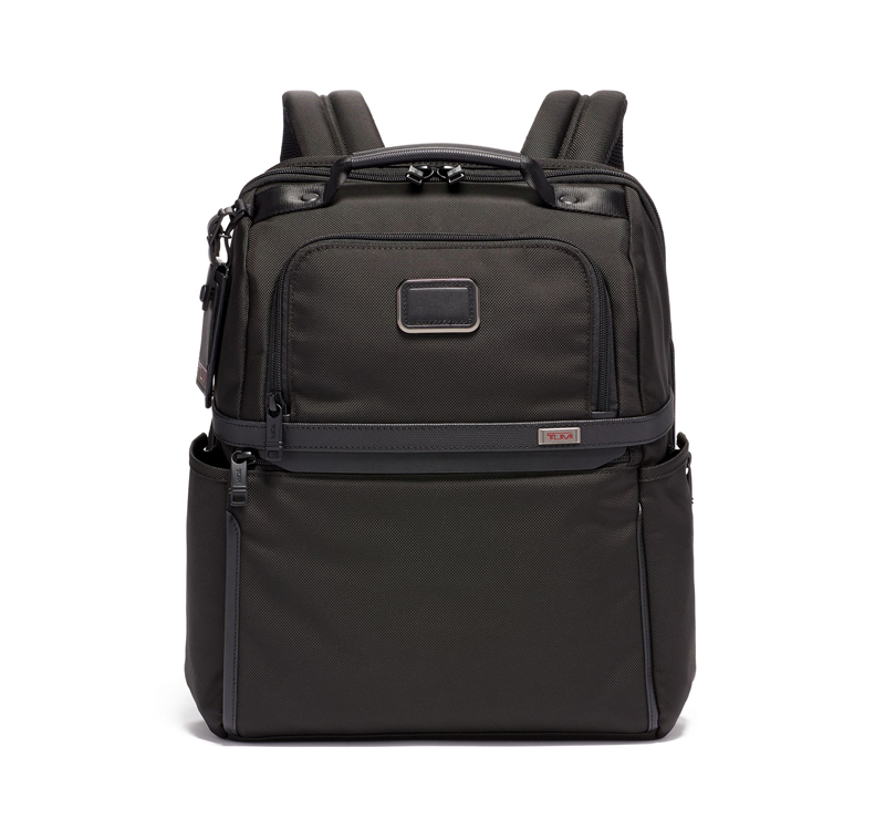 A black backpack with many compartments on it.