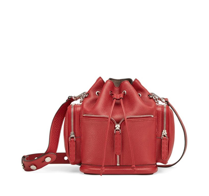 A red leather bag with two straps and one strap is open.