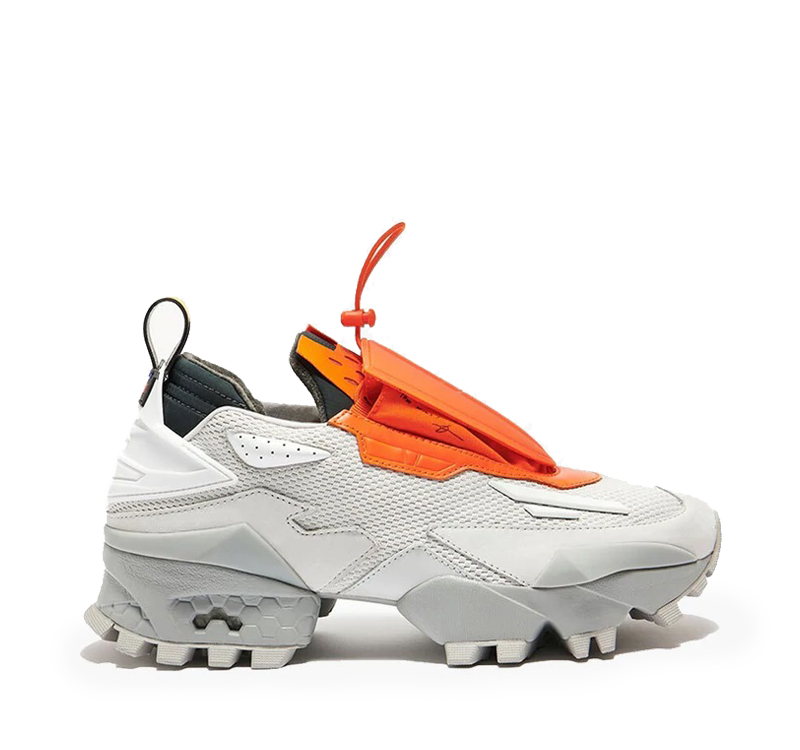 A pair of shoes with an orange tag attached to them.