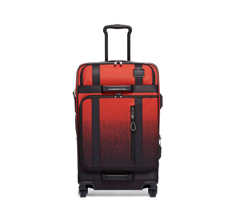 A red and black suitcase is shown on the ground.