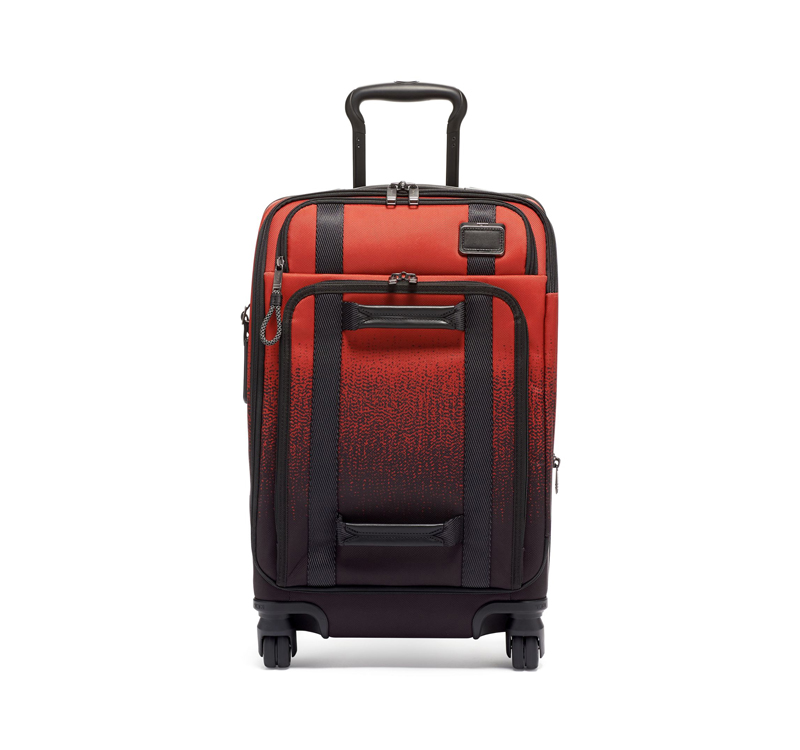 A red and black suitcase is shown on the ground.