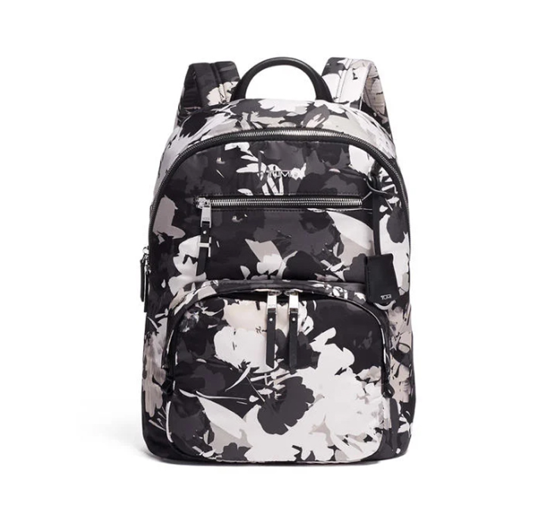 A black and white backpack with flowers on it.