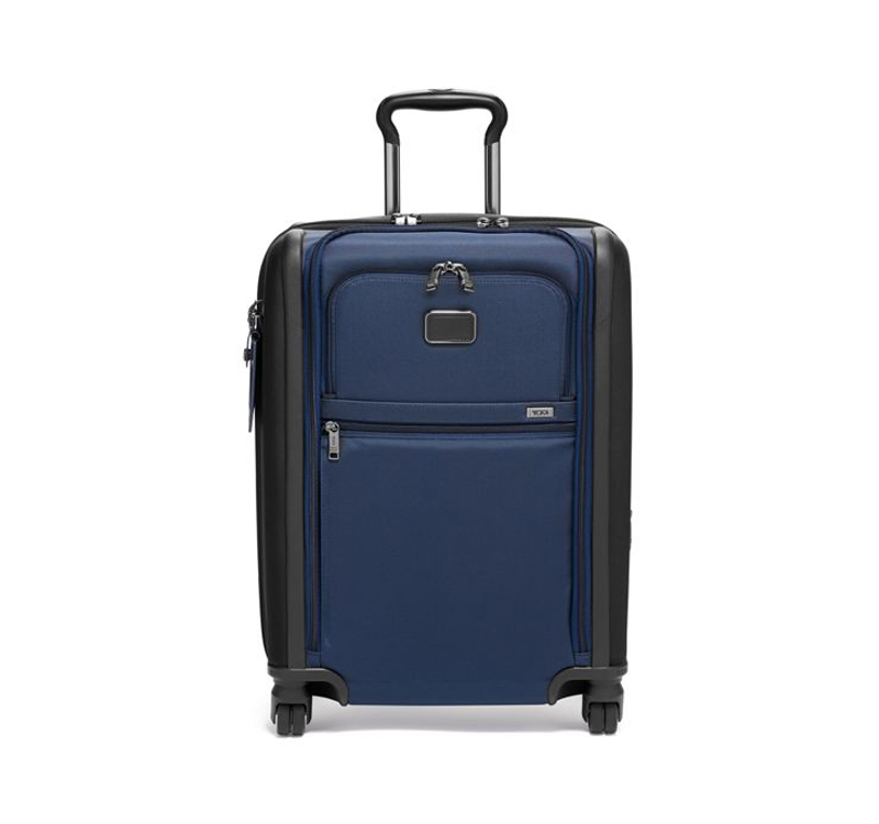 A blue suitcase is sitting on the ground.