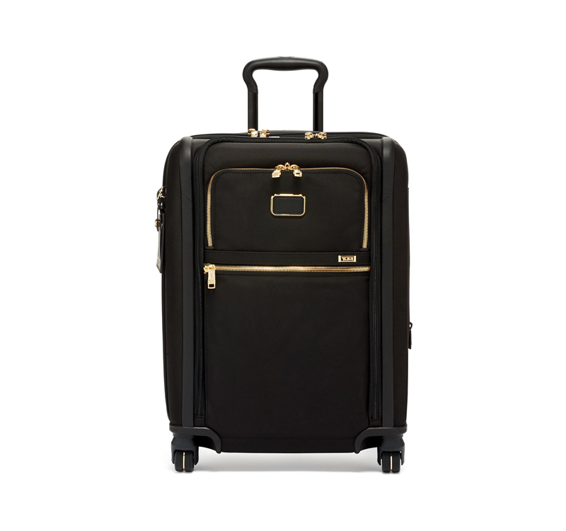 A black suitcase with gold trim on the bottom.