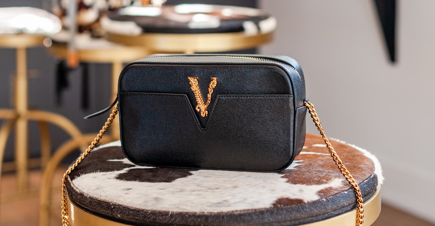 A black purse sitting on top of a table.