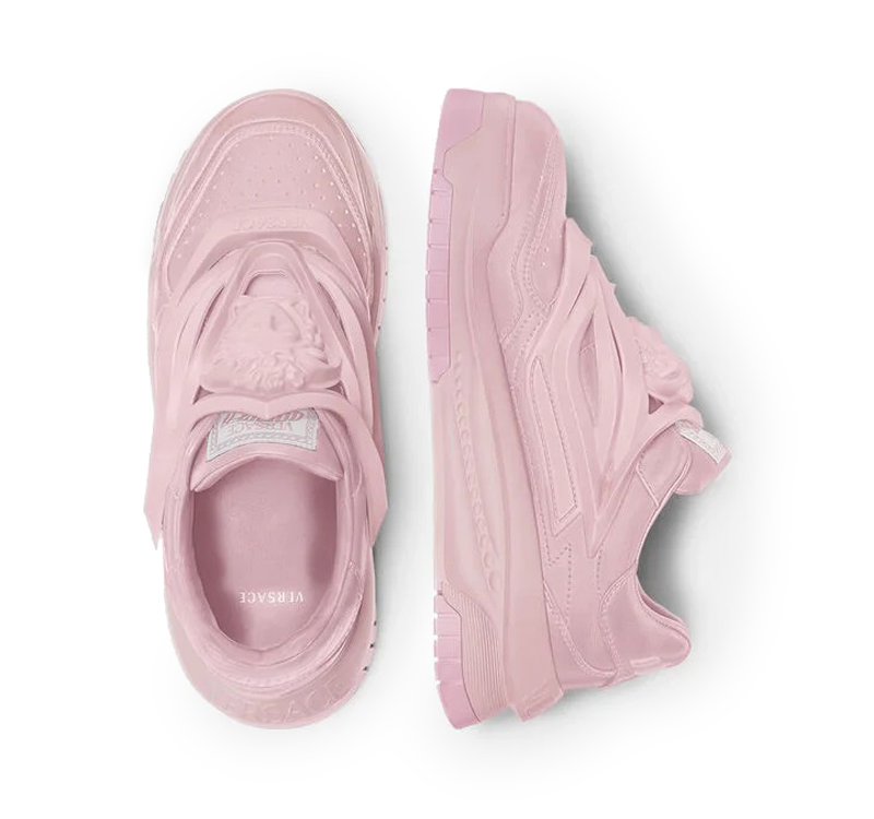 A pair of pink sneakers on top of each other.