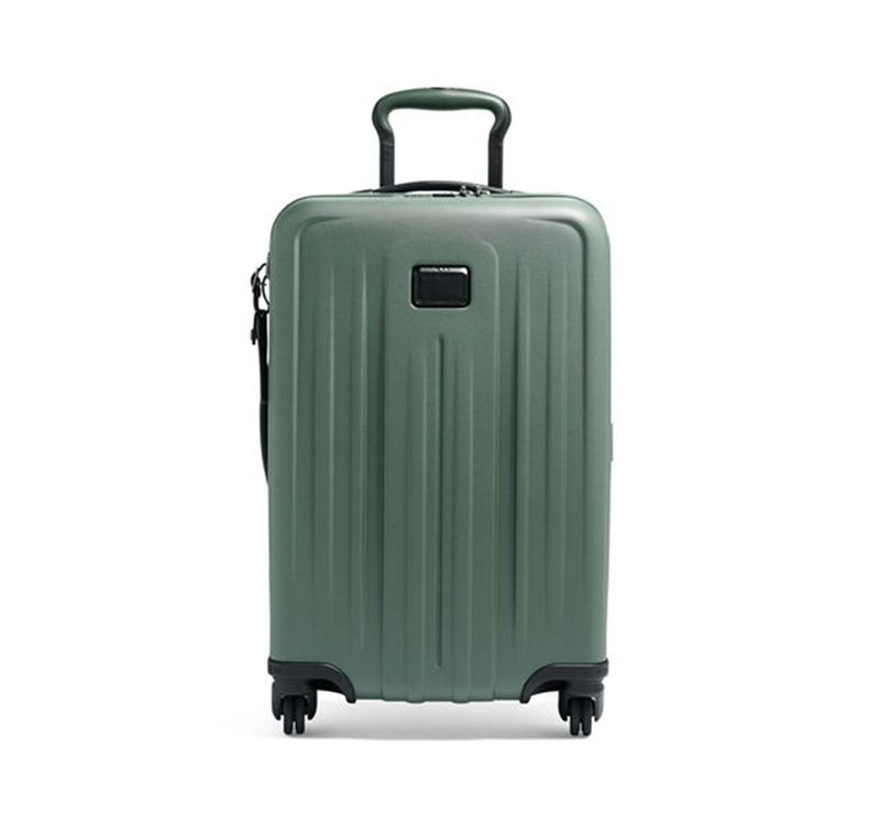 A green suitcase is shown with its wheels down.