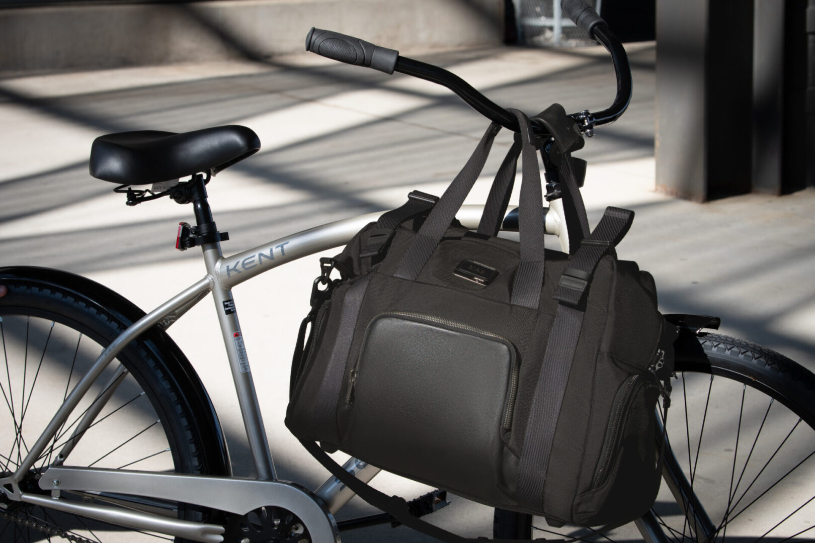 A bicycle with a bag on the back of it.